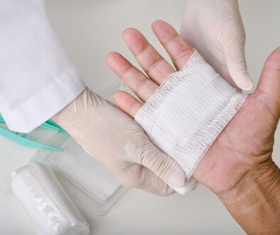 The caregiver cleans and dresses the patients' wounds.