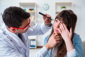 The doctor checks why the woman has dry eyes.