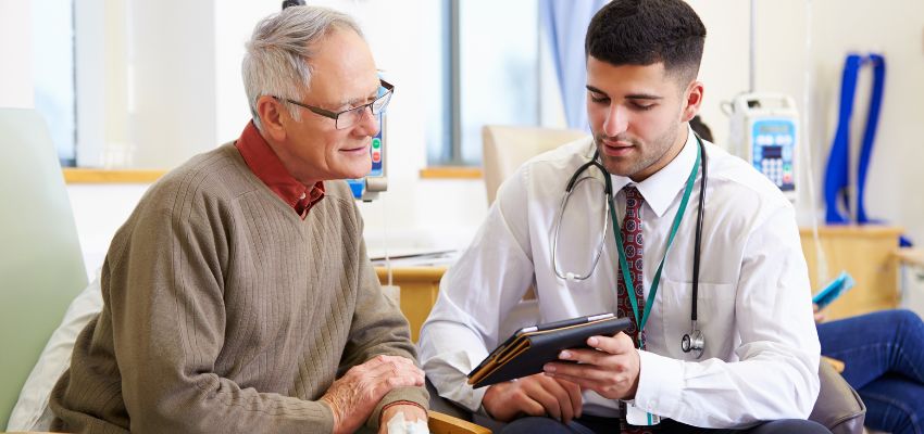 The doctor discusses with the elderly patient how HCT/P is used in therapies to repair, replace, or regenerate damaged body parts.