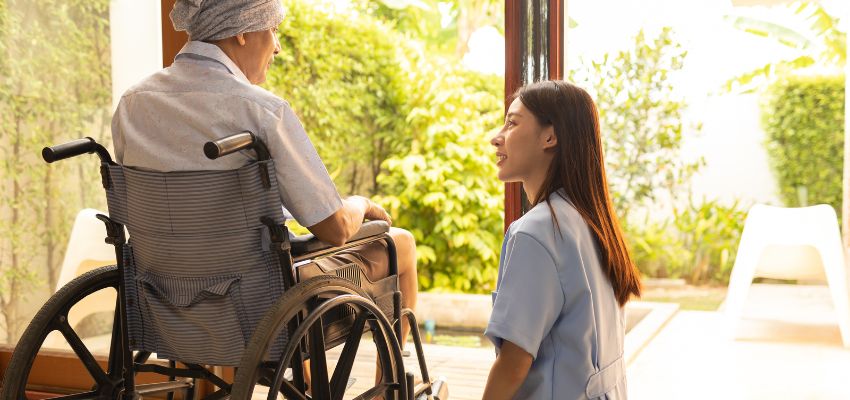 The caregiver inspects the patient's skin daily to prevent pressure sores.