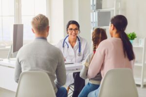The doctor happily discusses the benefits of regenerative medicine with the family.