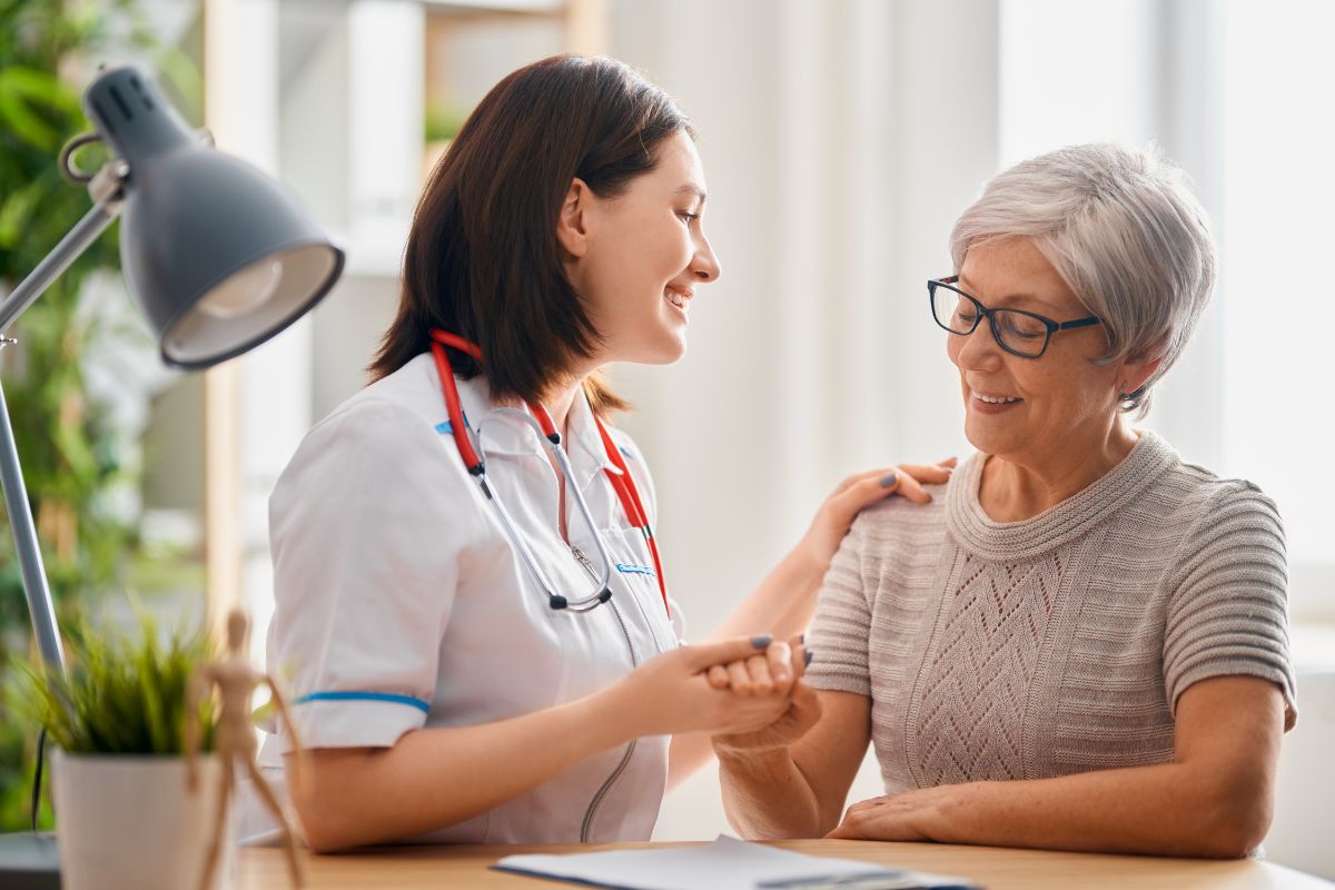 The doctor happily discusses how regenerative medicine treatment can help the older woman.