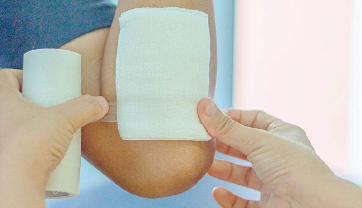 The caregiver uses an antimicrobial dressing for wound healing.