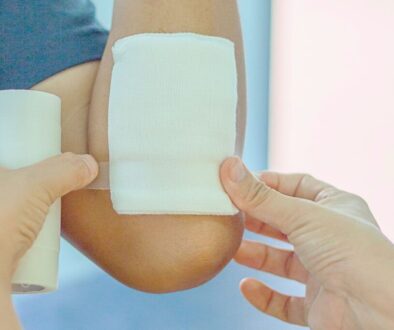 The caregiver uses an antimicrobial dressing for wound healing.