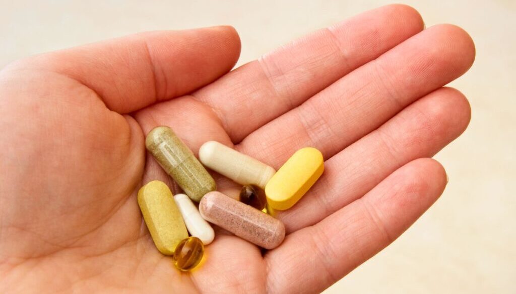 The man holds vitamins that are good for wound healing.