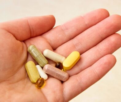 The man holds vitamins that are good for wound healing.